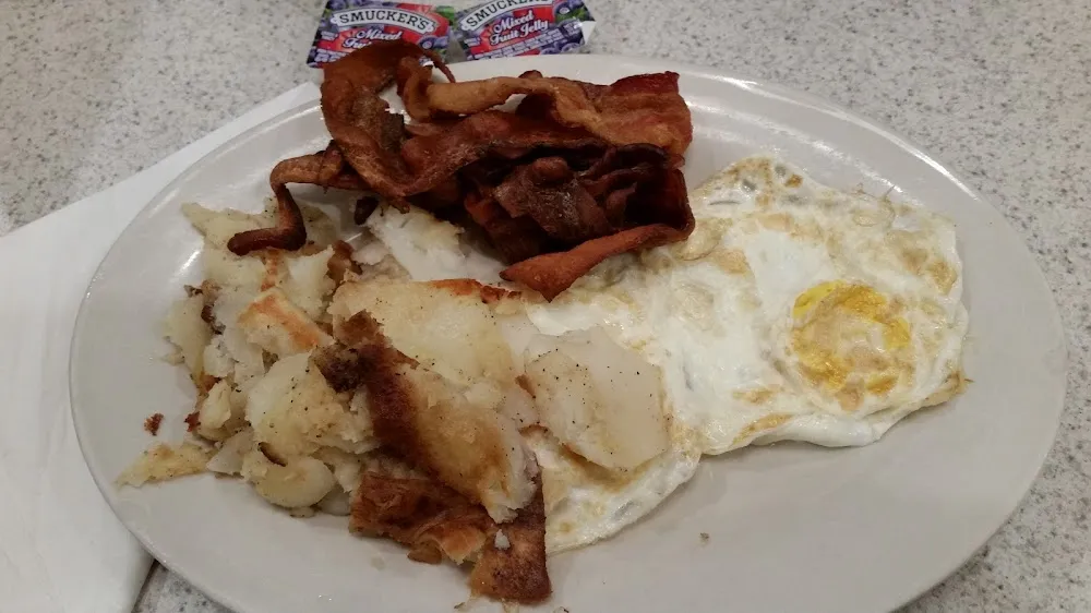 Breakfast Special 4 Two Eggs over Medium White Toast and Crispy Bacon